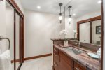 Granite counter tops, custom tile work, lighting and cabinets make this an elegant space to get ready for the day